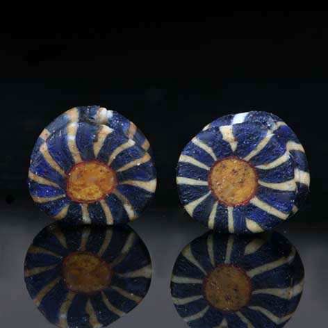 Two ancient mosaic glass beads, perforated flower mosaic cane